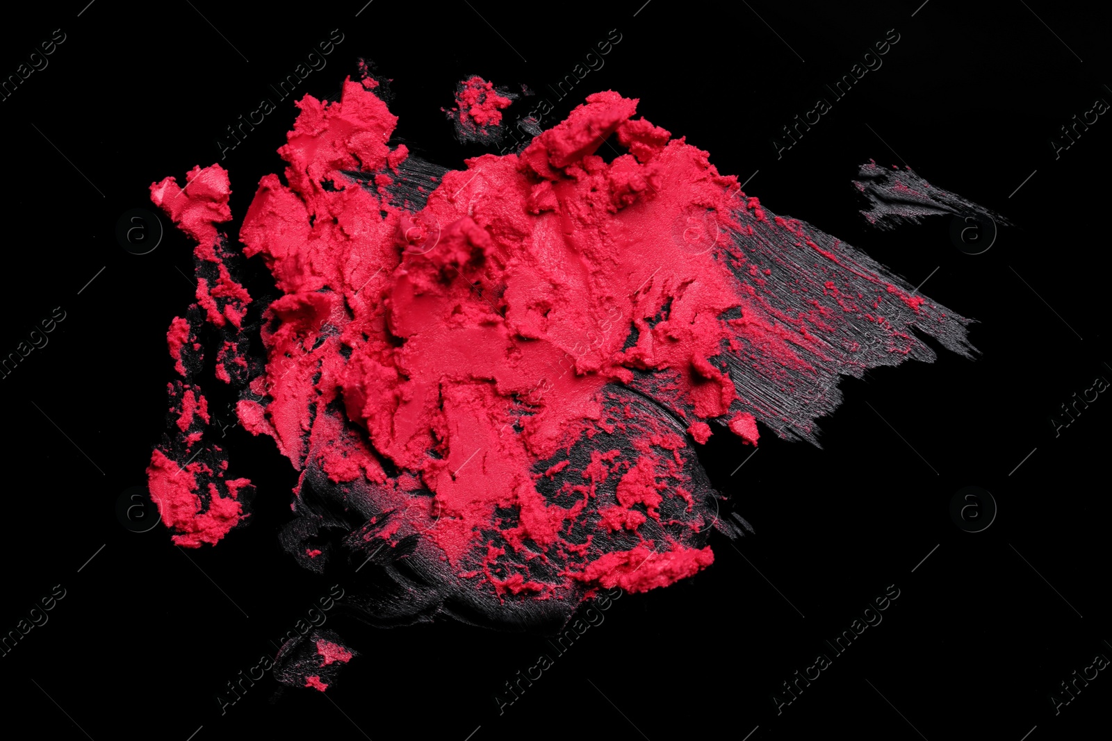 Photo of Smears of red lipstick on black background, top view