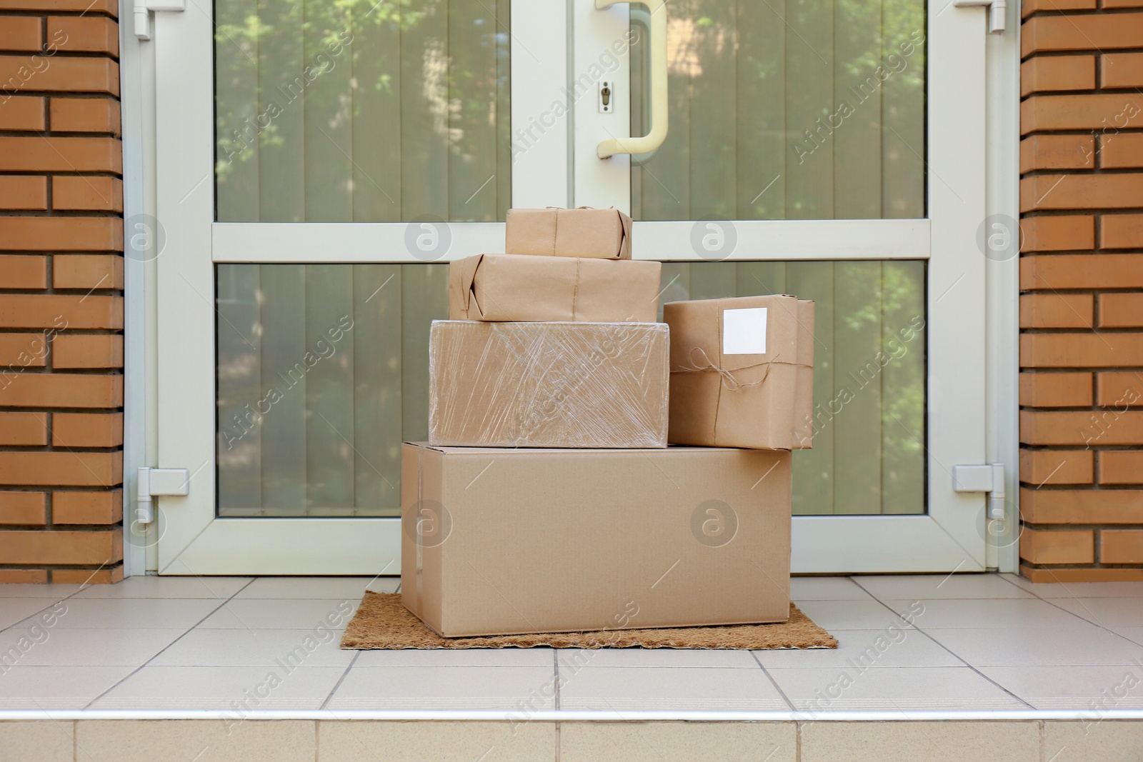 Photo of Delivered parcels on door mat near entrance