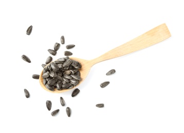 Raw organic sunflower seeds in wooden spoon isolated on white