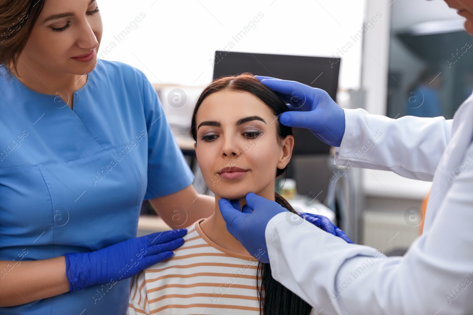 Photo of Professional doctors examining patient before surgery in clinic