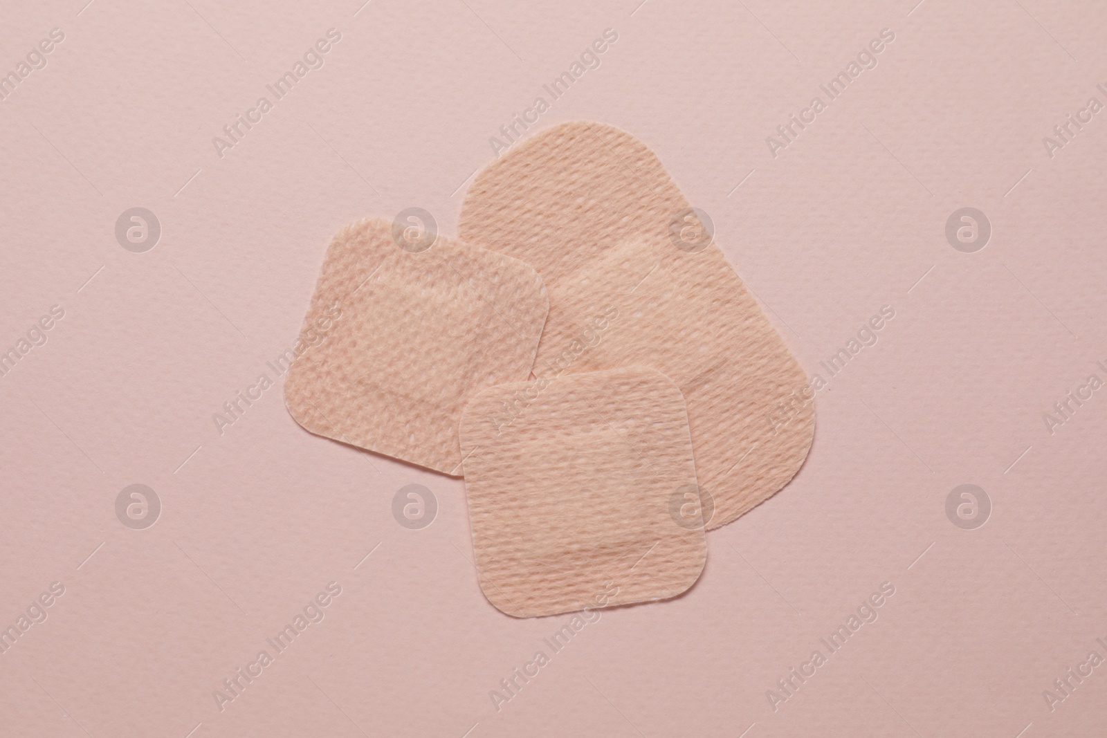 Photo of Contraceptive patches on pink background, flat lay