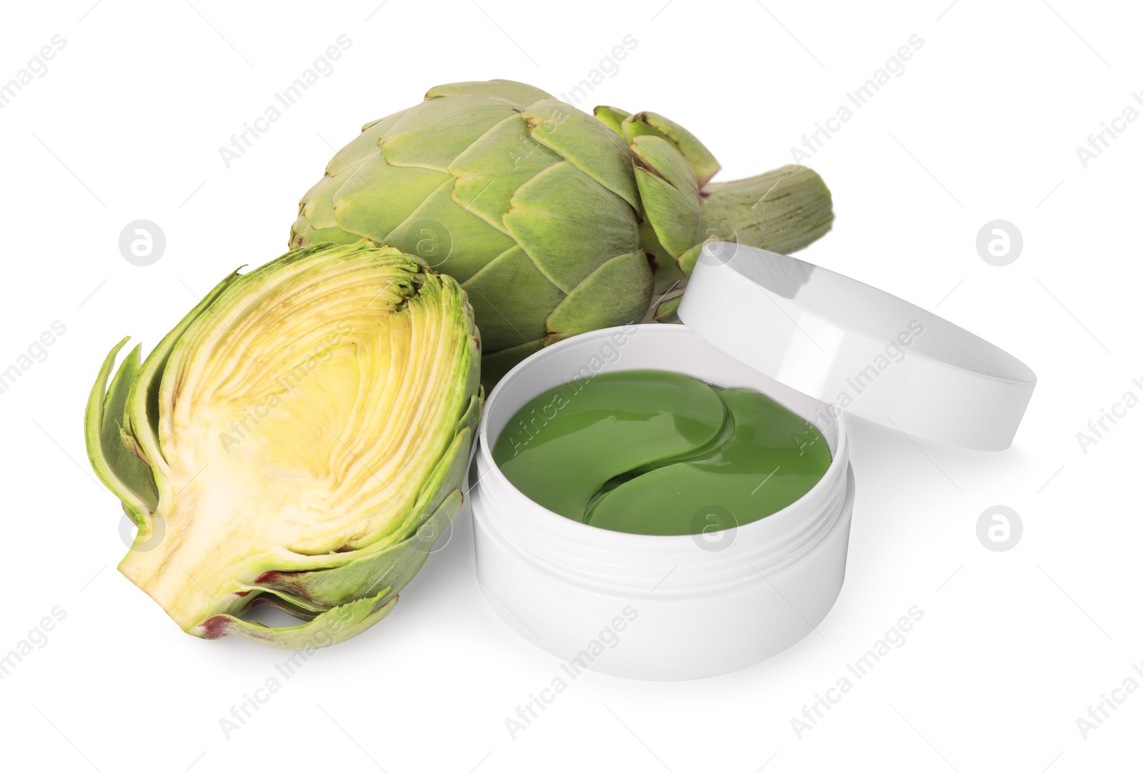 Photo of Package of under eye patches and artichokes on white background. Cosmetic product