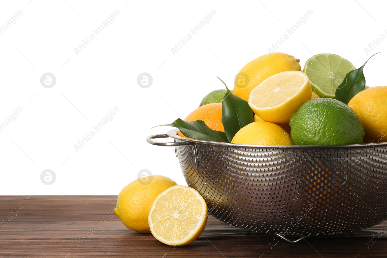 Photo of Metal colander with citrus fruits on wooden table against white background, space for text