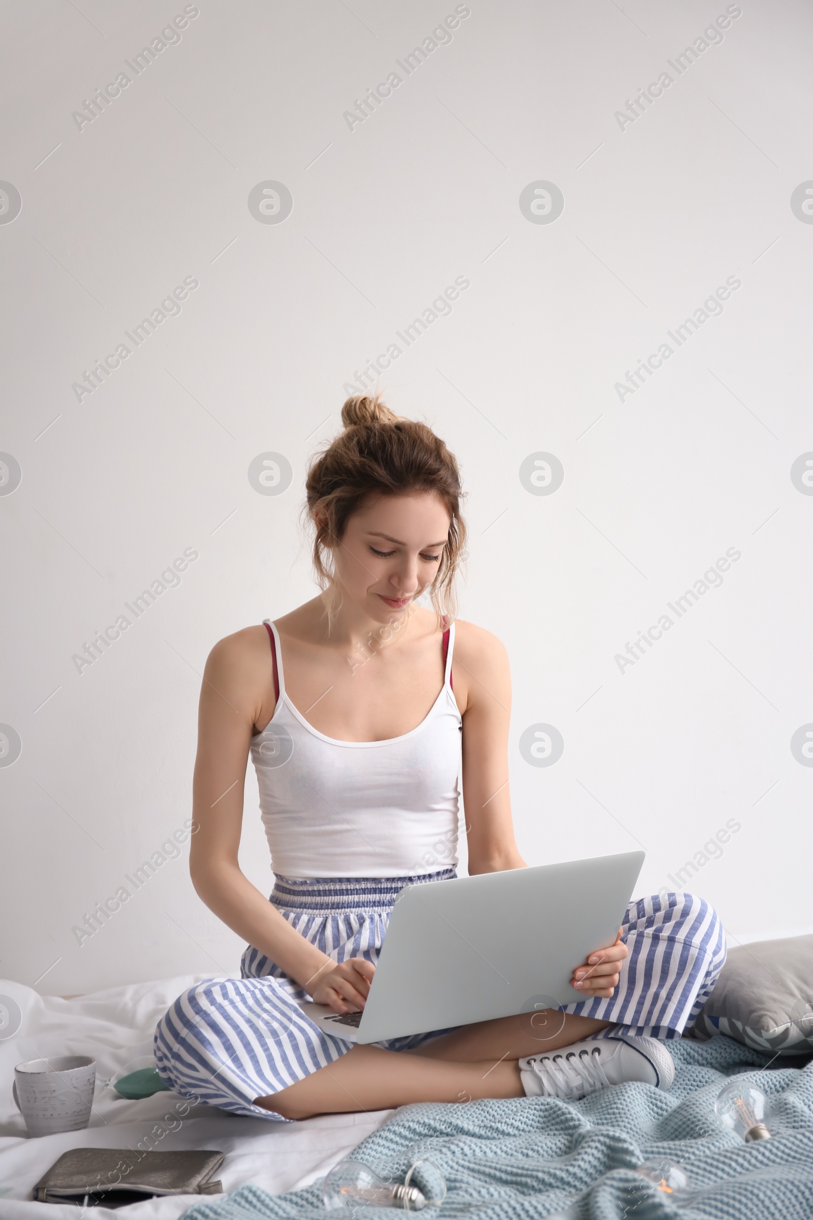 Photo of Female blogger with laptop on bed