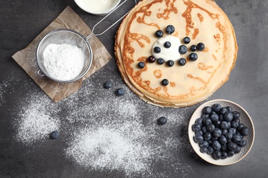 Photo of Flat lay composition with thin pancakes and berries on table