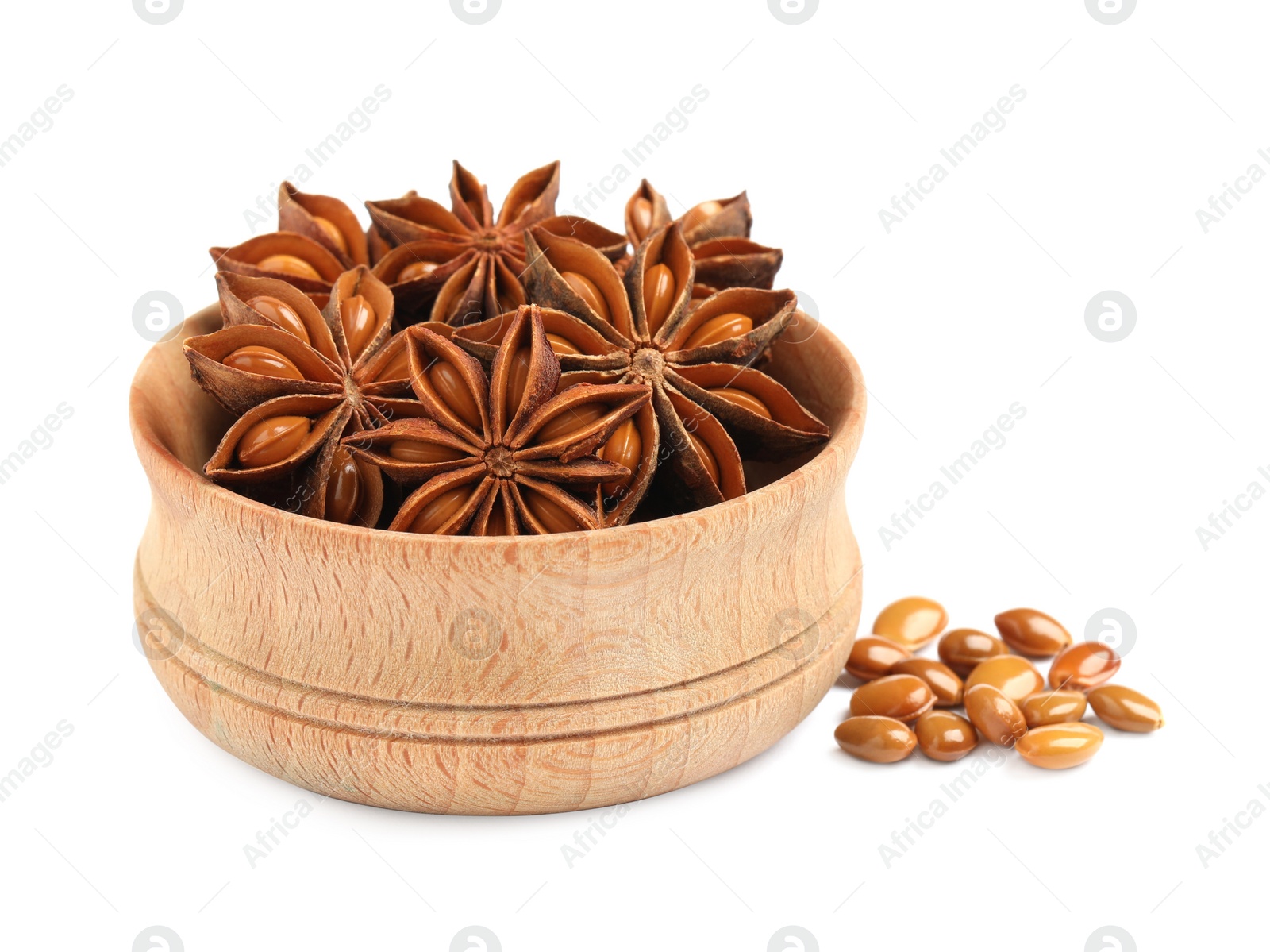 Photo of Wooden bowl with dry anise stars and seeds on white background