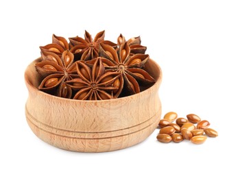 Photo of Wooden bowl with dry anise stars and seeds on white background