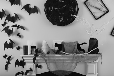 Photo of Different Halloween decor on fireplace in room