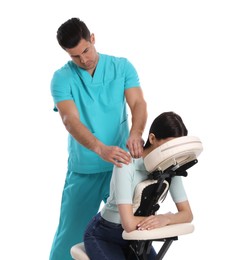 Photo of Woman receiving massage in modern chair on white background