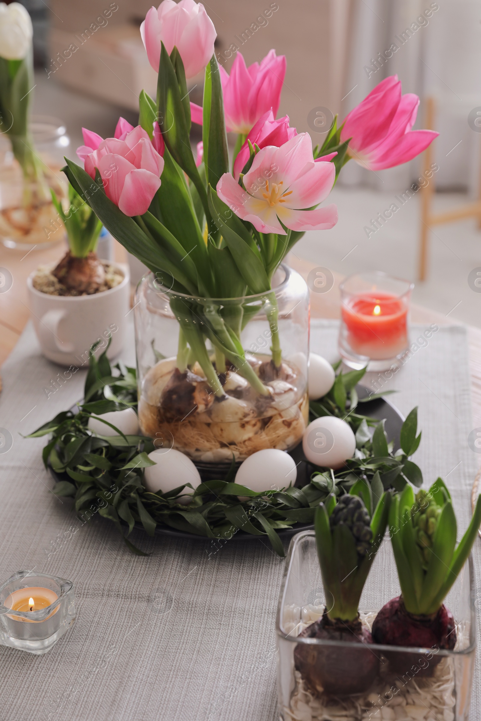 Photo of Beautiful Easter table setting with beautiful flowers indoors