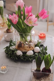 Beautiful Easter table setting with beautiful flowers indoors