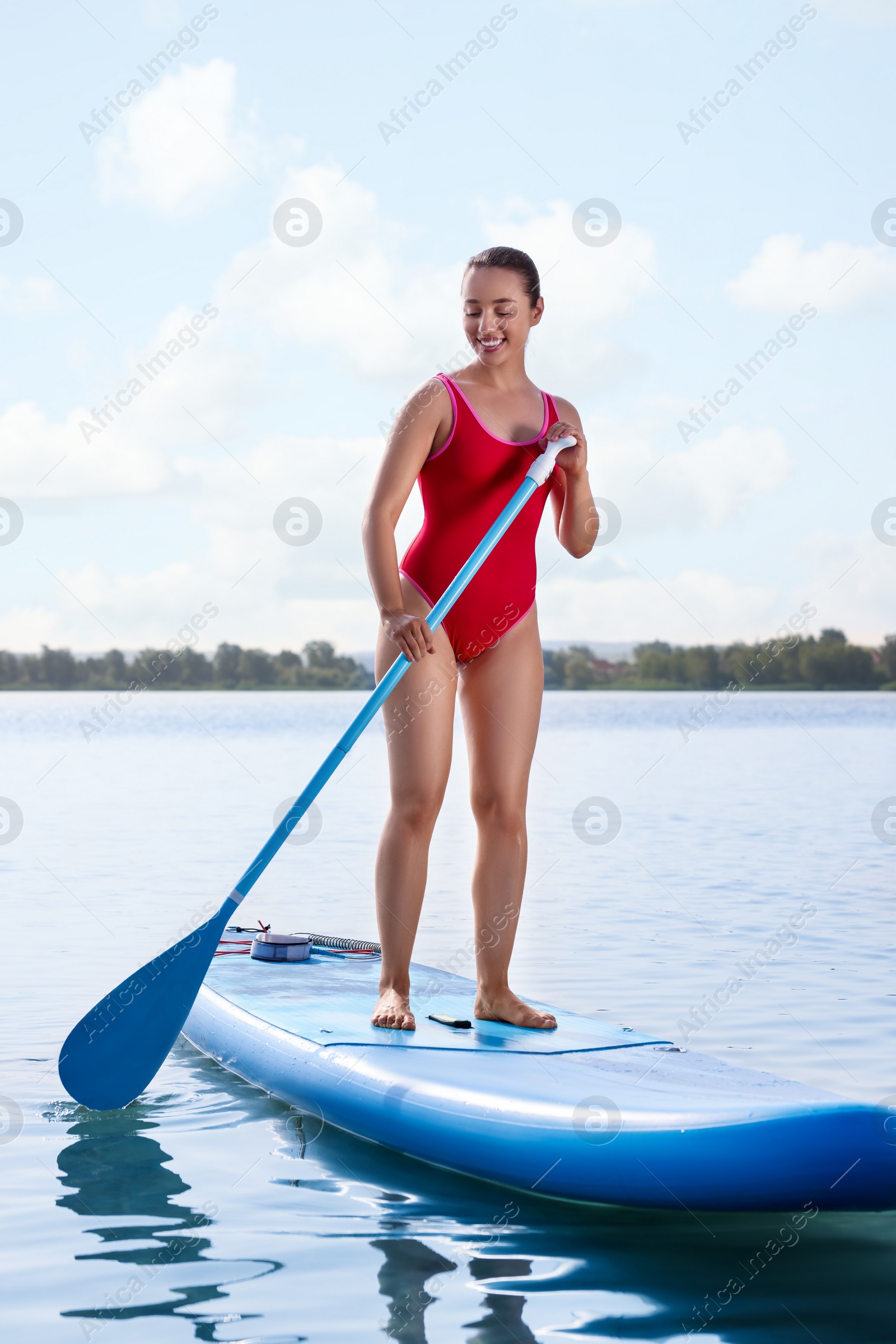 Photo of Woman paddle boarding on SUP board in sea