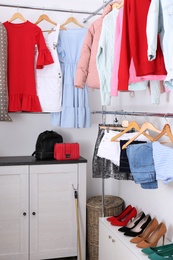 Modern dressing room with different stylish clothes and shoes