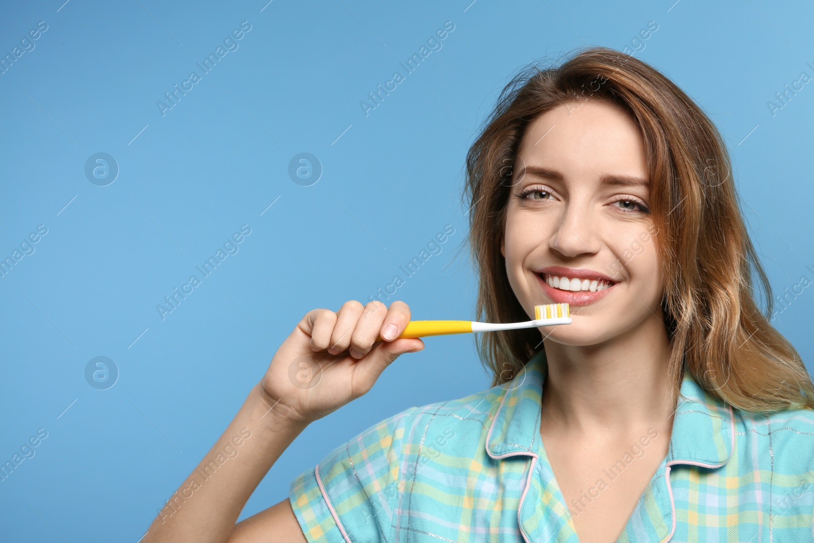 Photo of Portrait of young woman with toothbrush on color background. Space for text