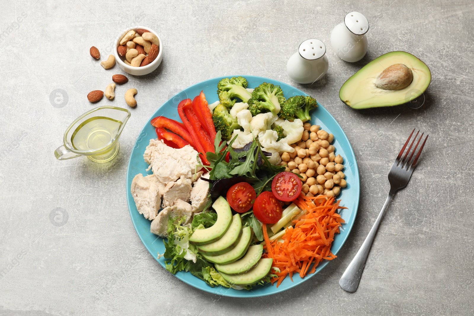 Photo of Balanced diet and healthy foods. Plate with different delicious products on grey table, flat lay