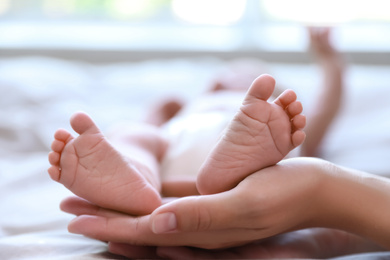 Photo of Mother and her newborn baby on bed, closeup