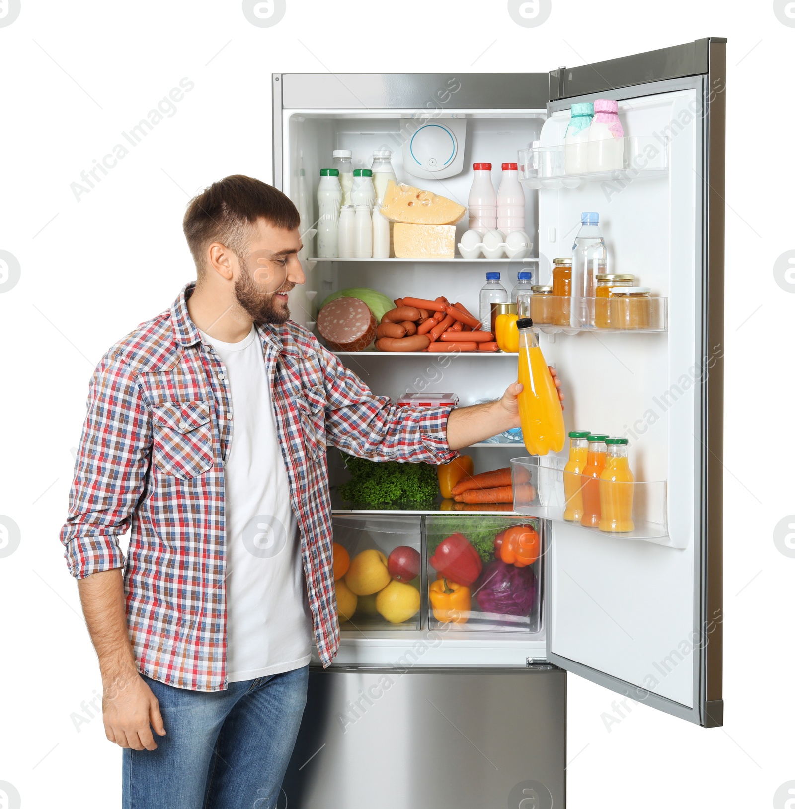 Photo of Young man taking bottle of juice from refrigerator on white background