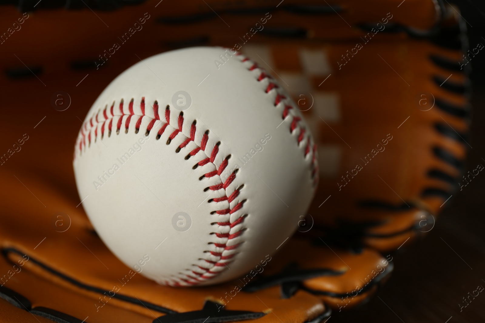 Photo of Professional leather baseball ball and glove, closeup