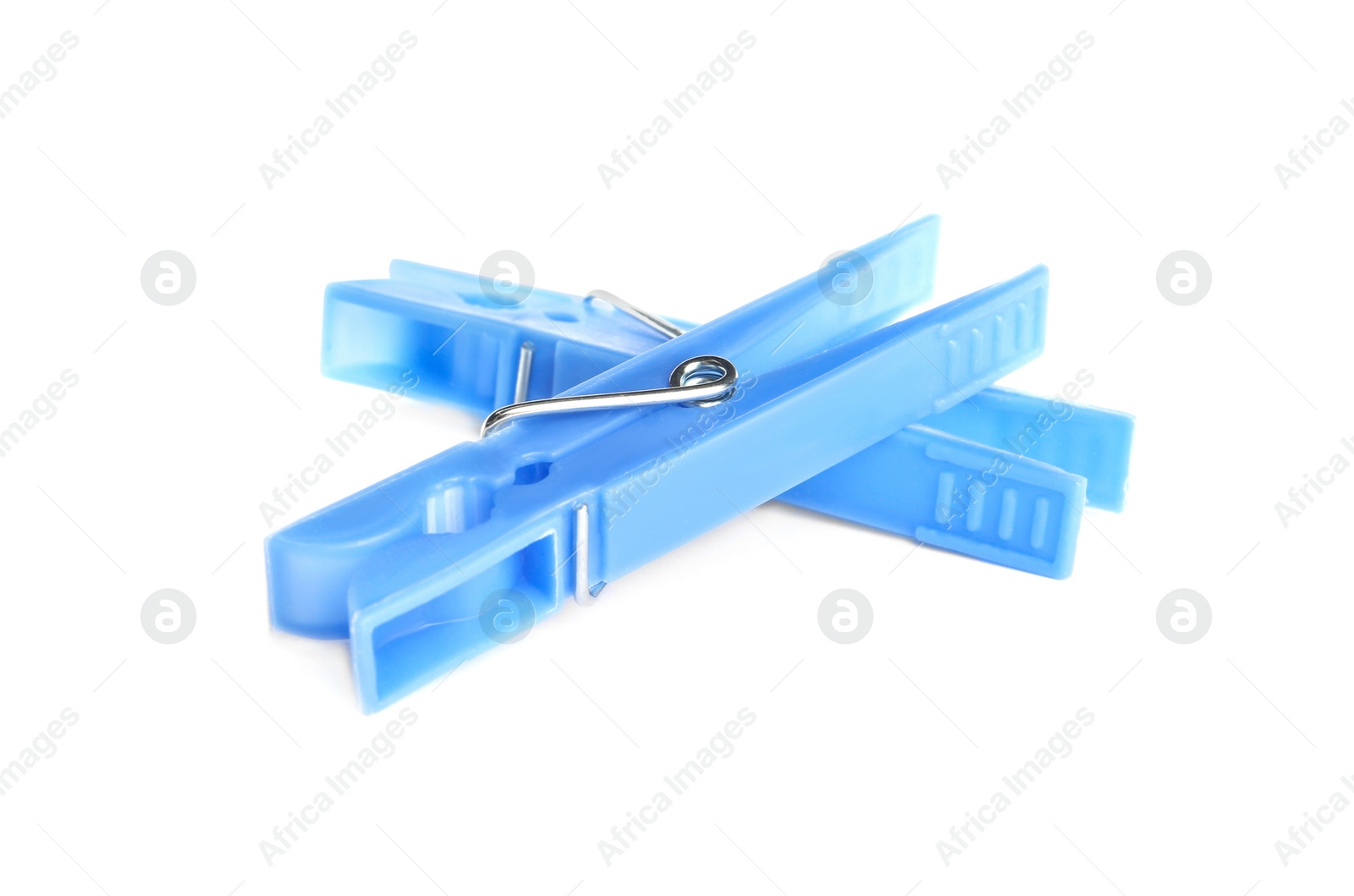 Photo of Light blue plastic clothespins on white background