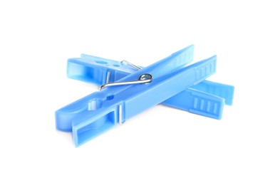 Photo of Light blue plastic clothespins on white background