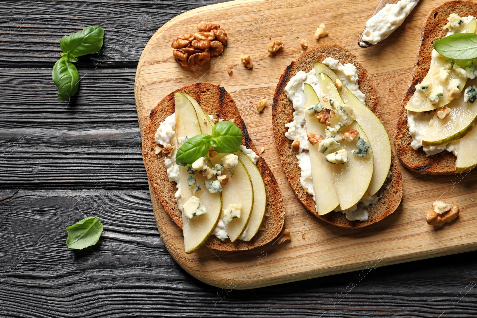 Photo of Bruschettas with pear served on table, flat lay