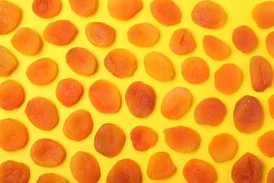 Photo of Flat lay composition with dried apricots on  color background. Healthy fruit