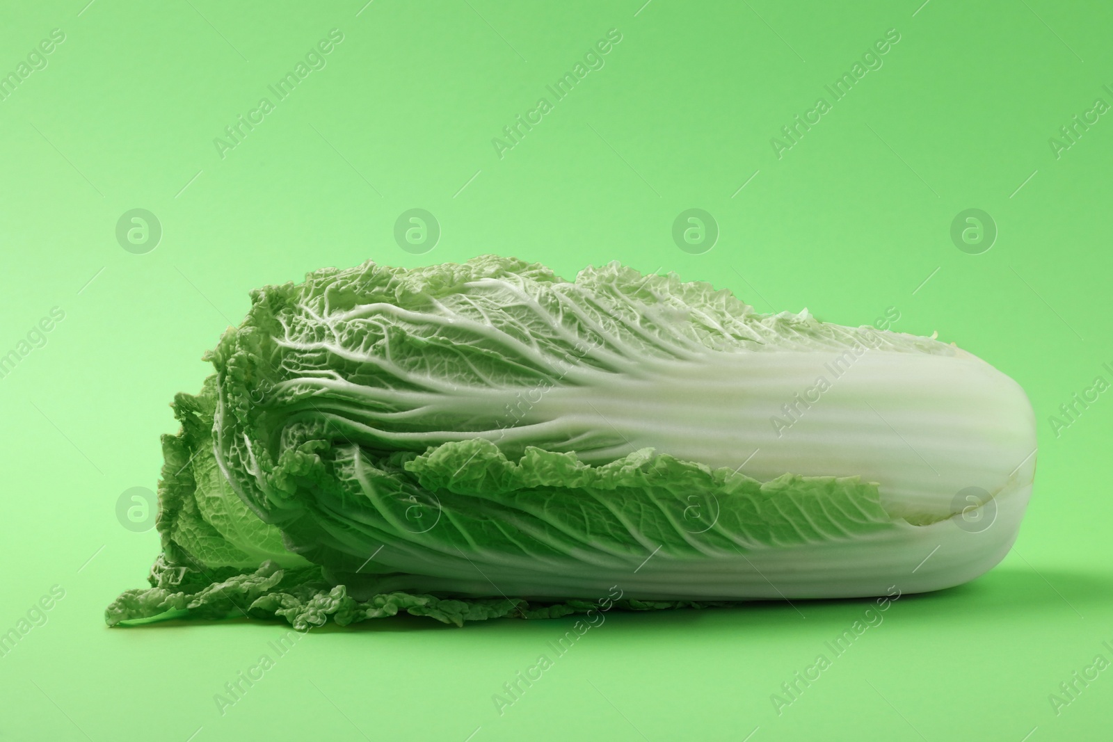 Photo of Fresh ripe Chinese cabbage on light green background