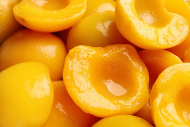 Photo of Halves of canned peaches as background, closeup