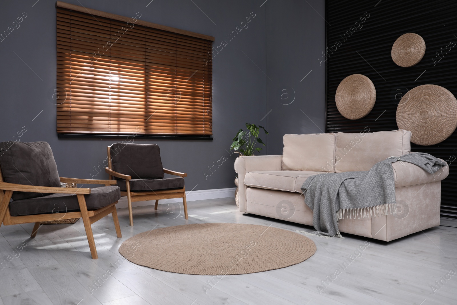 Photo of Stylish living room interior with comfortable sofa and armchairs