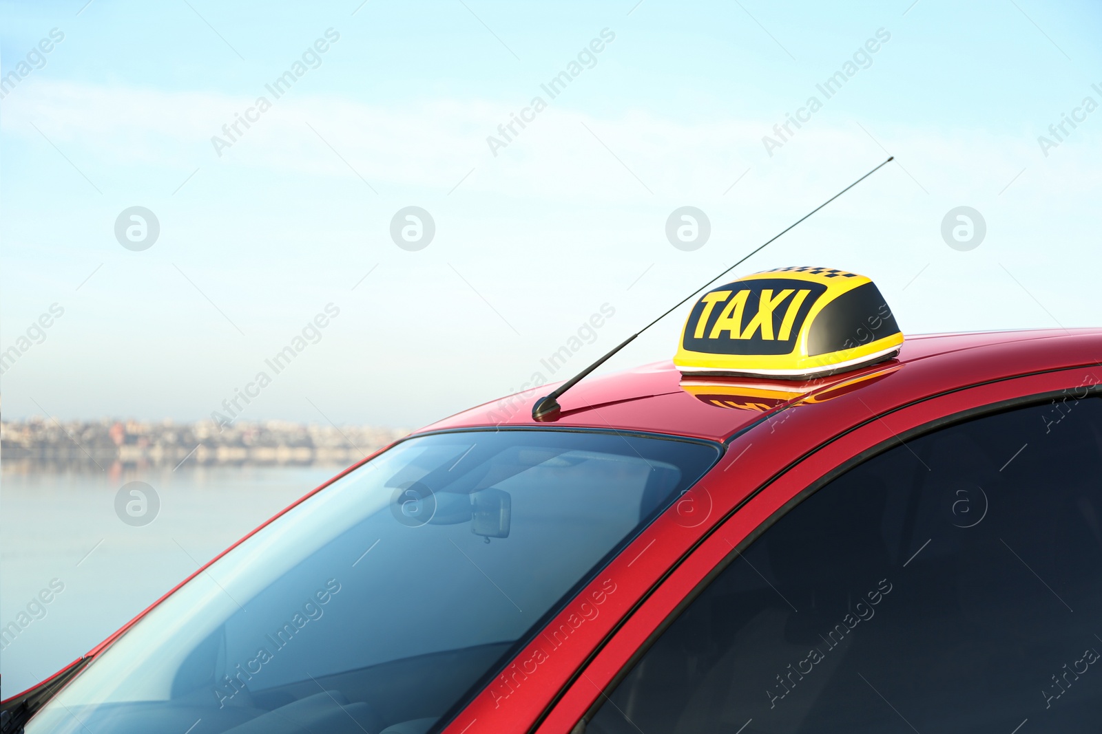 Photo of Roof light with word TAXI on car outdoors