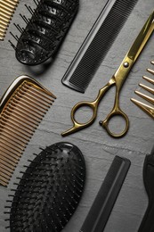 Photo of Hairdressing tools on grey textured background, flat lay