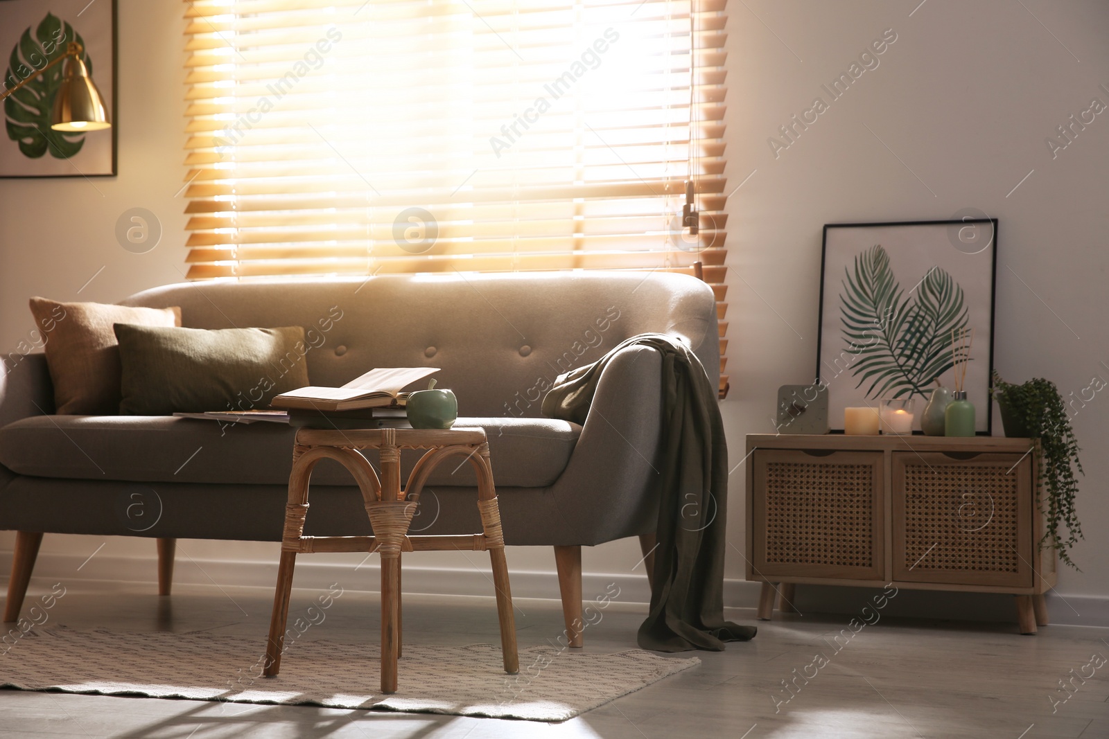 Photo of Stylish living room interior with stool and sofa