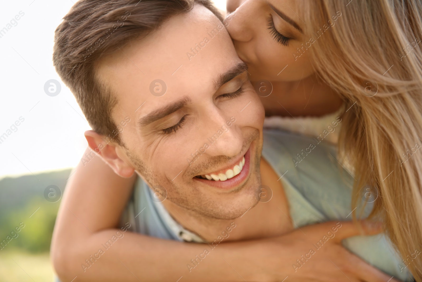 Photo of Cute young couple in love posing outdoors on sunny day