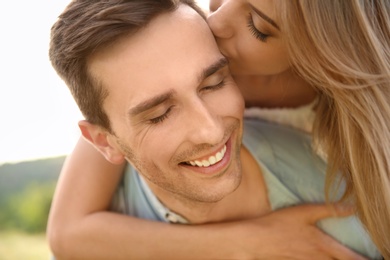 Photo of Cute young couple in love posing outdoors on sunny day