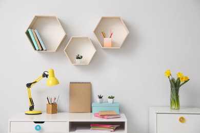 Photo of Comfortable workplace with wooden furniture and lamp