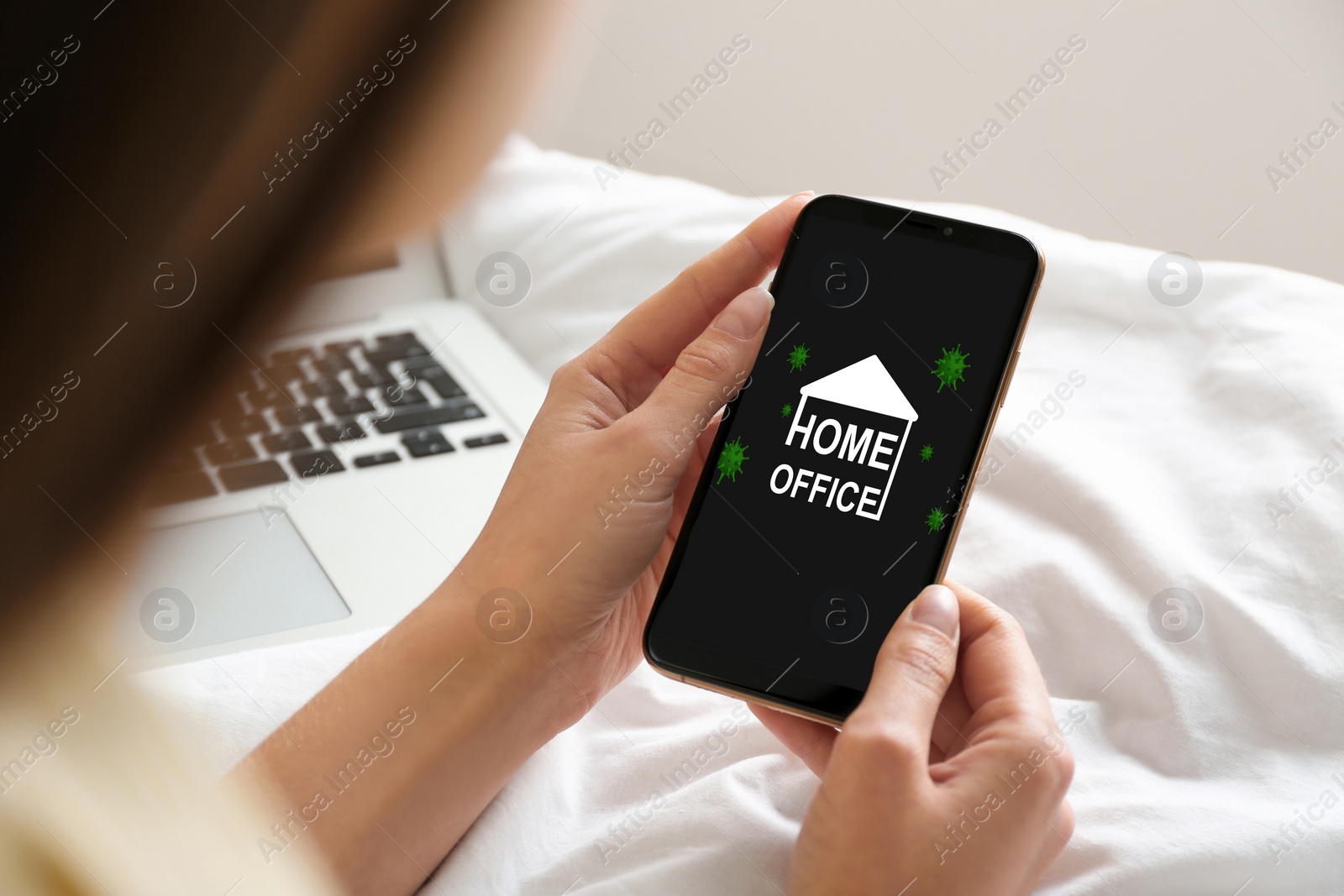 Image of Young woman using smartphone on bed indoors, closeup. Home office