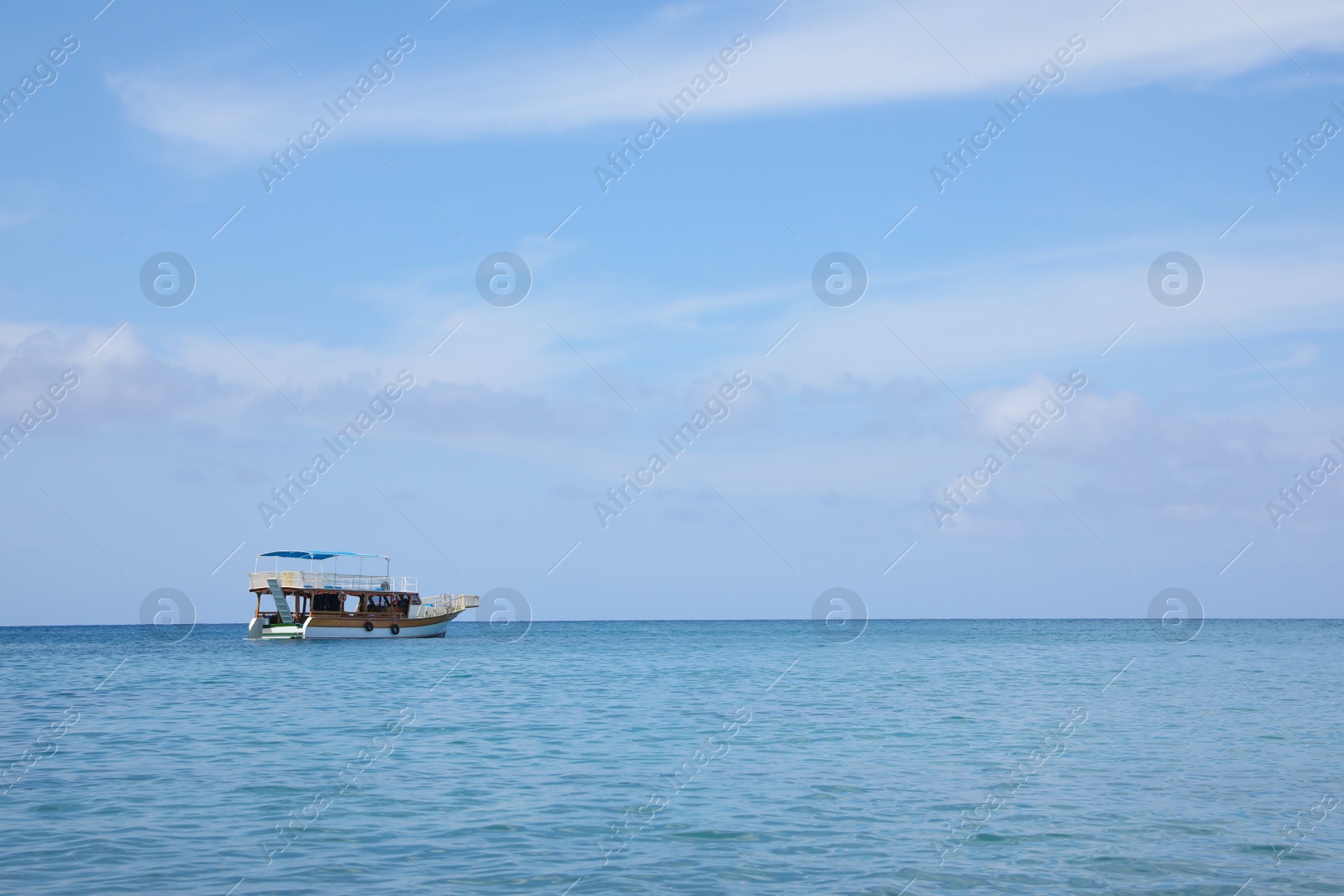 Photo of Beautiful view of tranquil sea and boat on sunny summer day