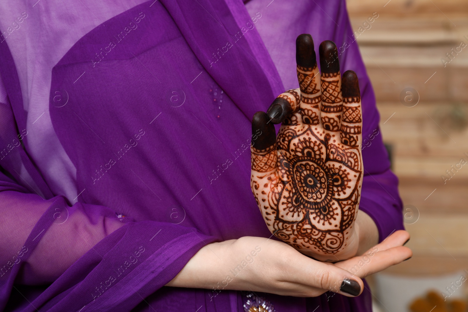 Photo of Woman with henna tattoo on palm, closeup and space for text. Traditional mehndi ornament