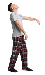 Photo of Somnambulist in pajamas on white background. Sleepwalking