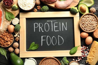 Chalkboard with written text Protein Food among natural products, top view