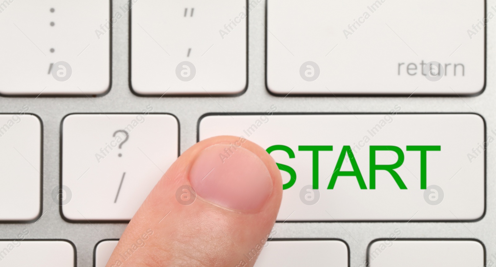 Image of Man pressing button with word Start on computer keyboard, closeup
