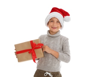 Photo of Cute little boy in Santa hat with Christmas gift on white background