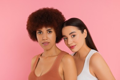 Photo of Portrait of beautiful young women on pink background