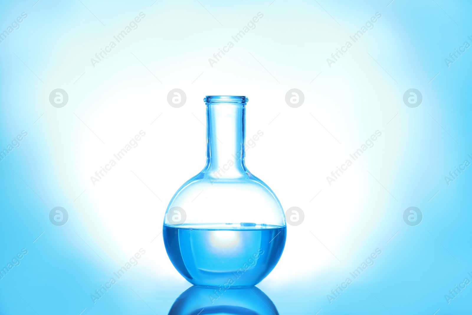 Photo of Laboratory flask with liquid on color background. Solution chemistry