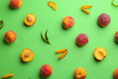 Photo of Flat lay composition with fresh peaches on green background