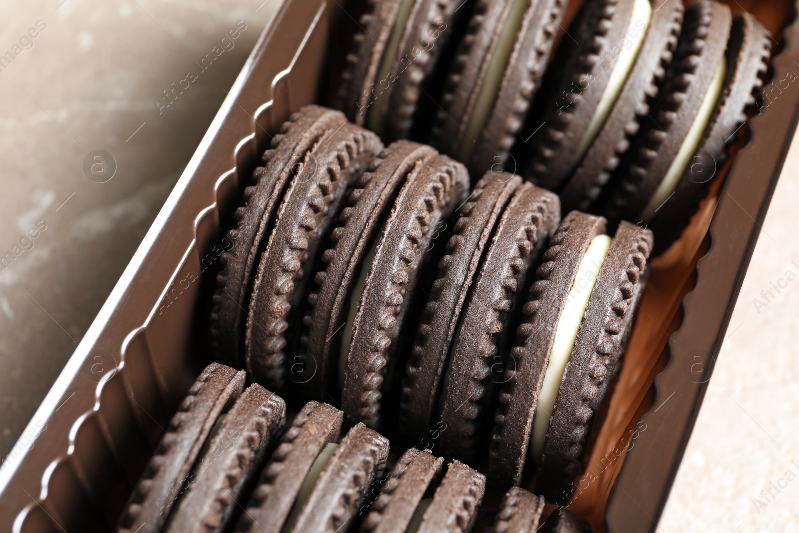 Photo of Box with chocolate and cream cookies, closeup