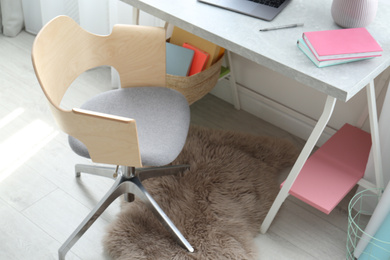 Photo of Comfortable workplace with office chair and modern table