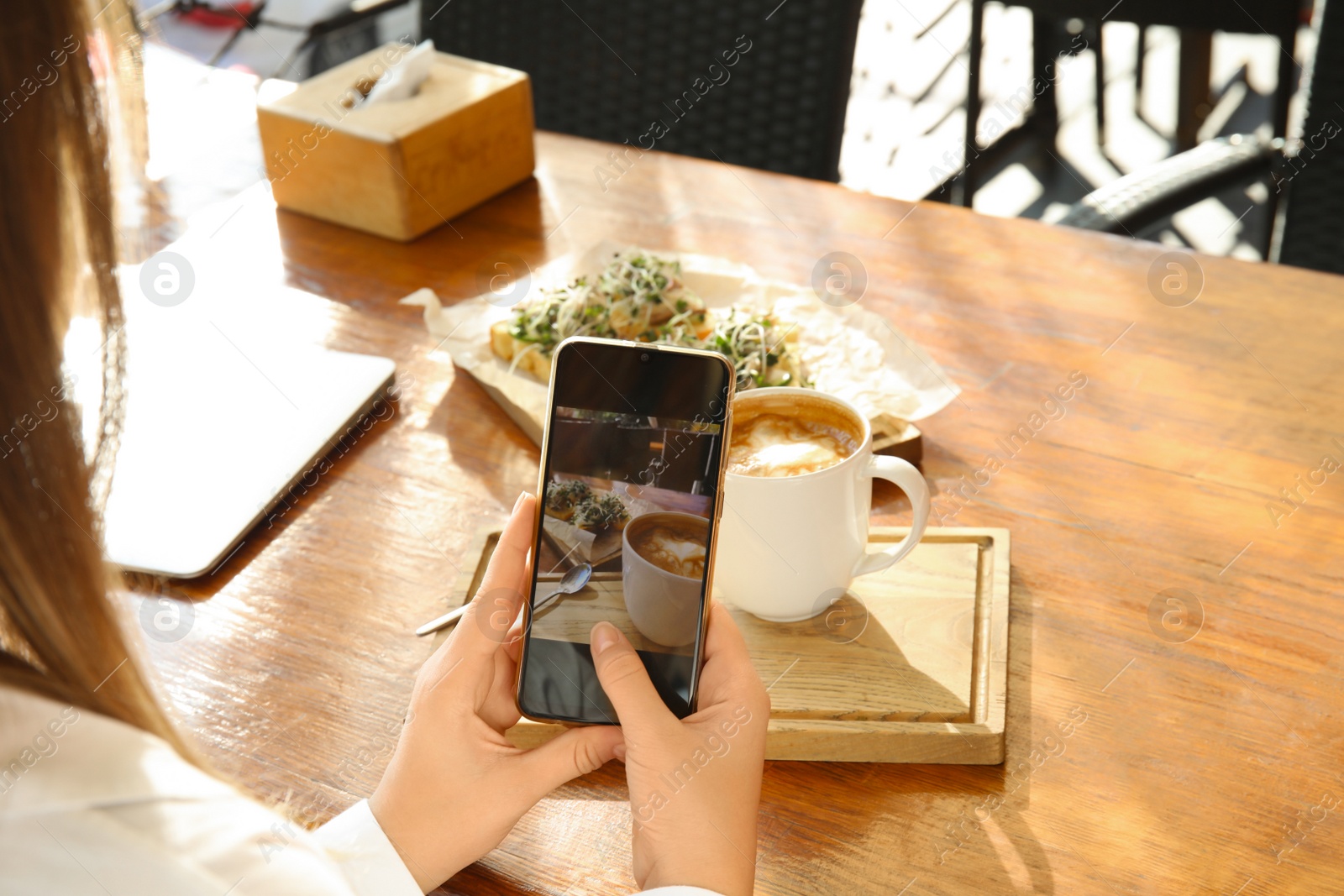 Photo of Food blogger taking photo of her lunch at cafe, closeup