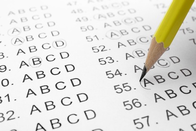 Photo of Filling answer sheet with pencil, closeup view