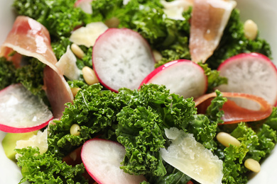 Photo of Tasty fresh kale salad as background, closeup